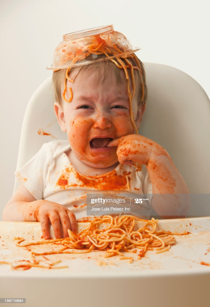 Baby Eating Spaghetti
 Crying Mixed Race Baby Boy Eating Spaghetti Stock