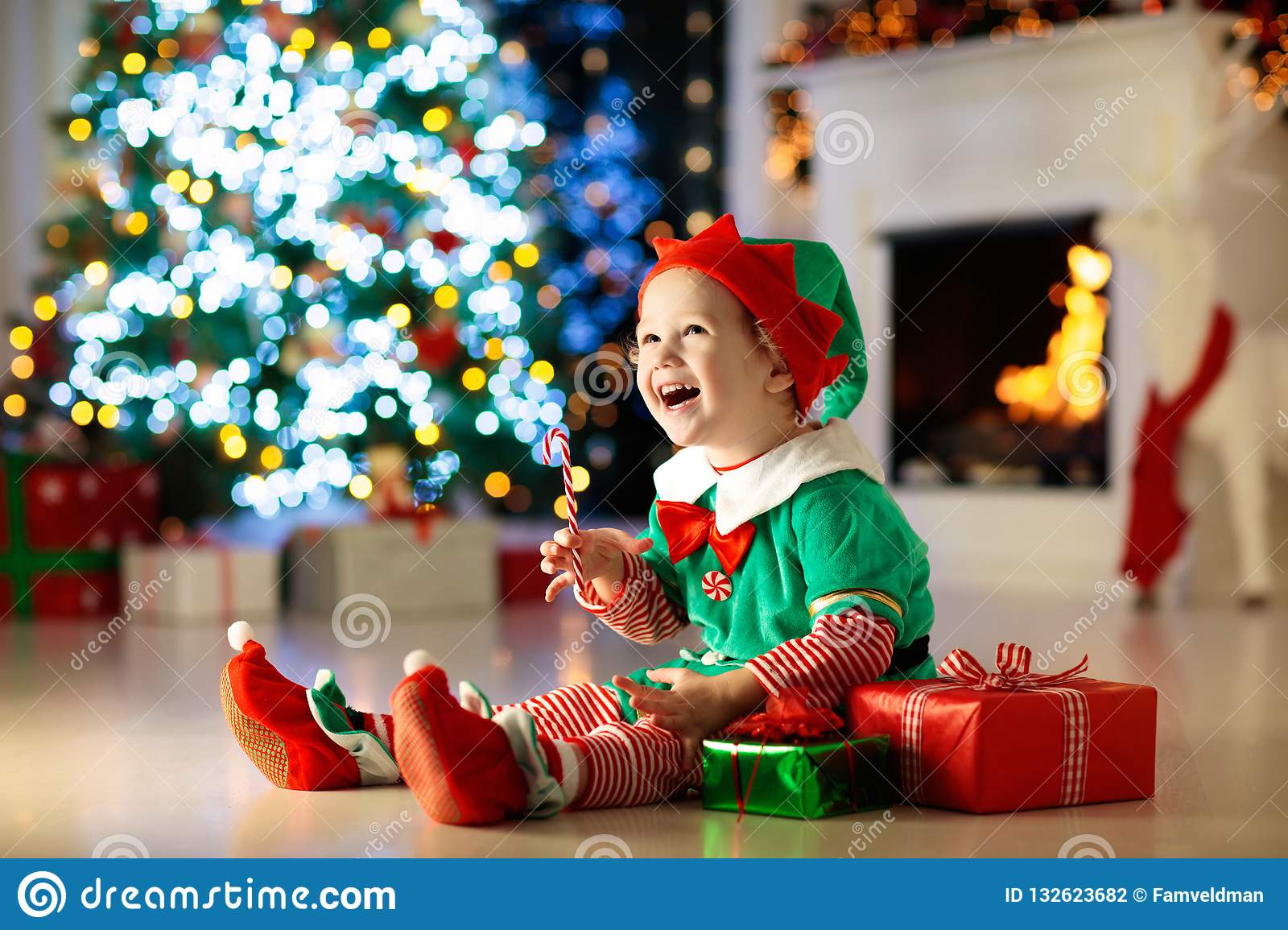 Child Gifts
 Kids At Christmas Tree Children Open Presents Stock