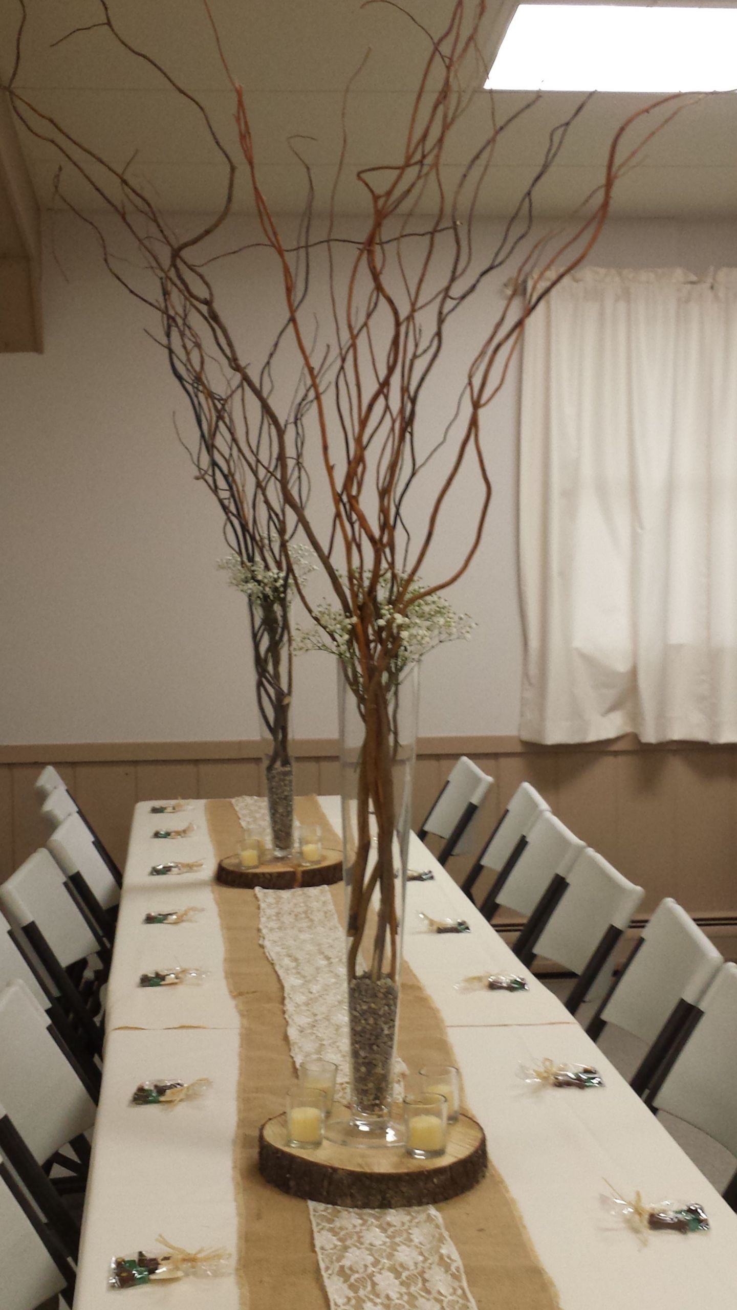 DIY Wood Slab Centerpieces
 Tall curly willows with baby shower breath in a trumpet