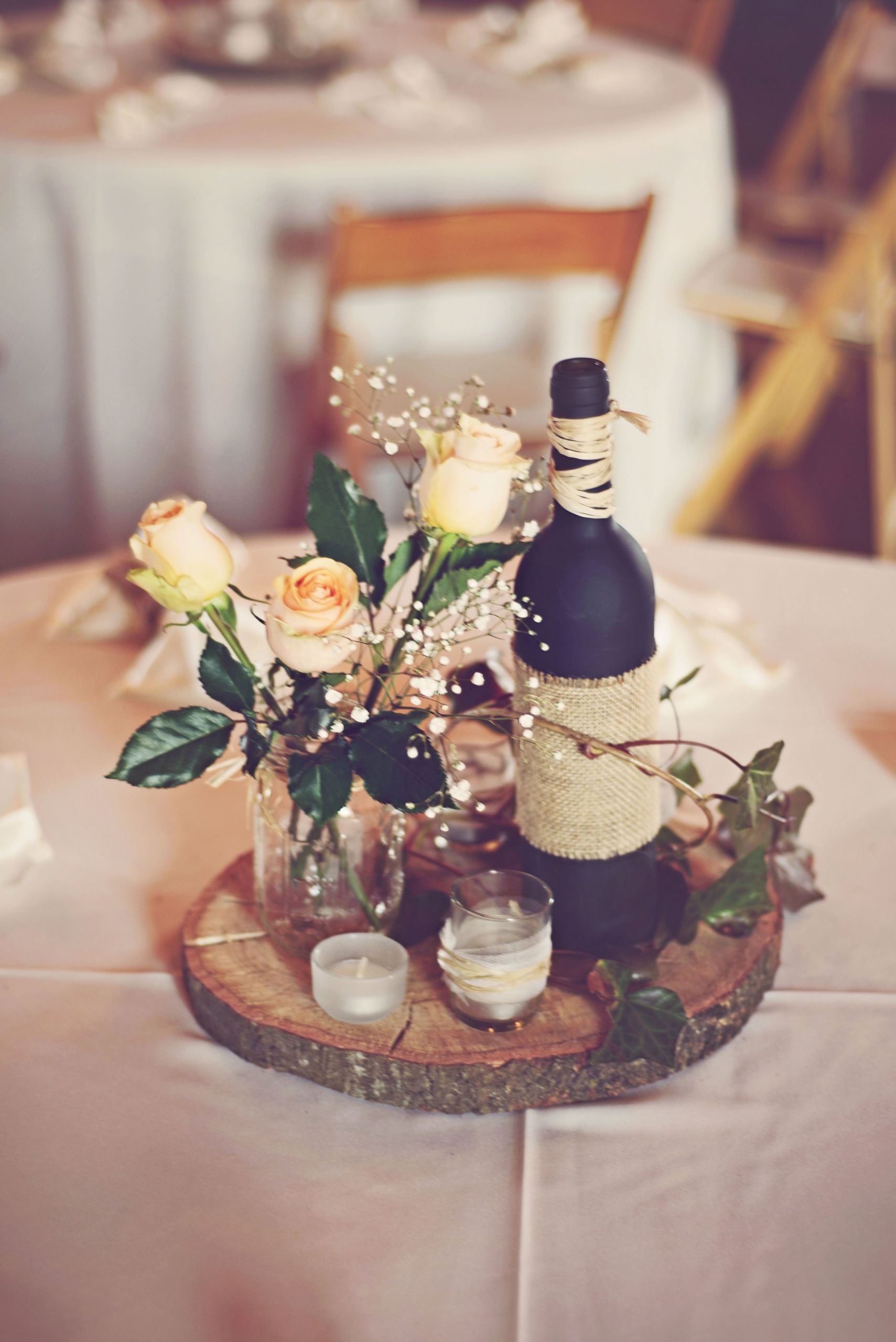 DIY Wood Slab Centerpieces
 DIY Rustic Centerpiece with Rose Buds and Wood Round