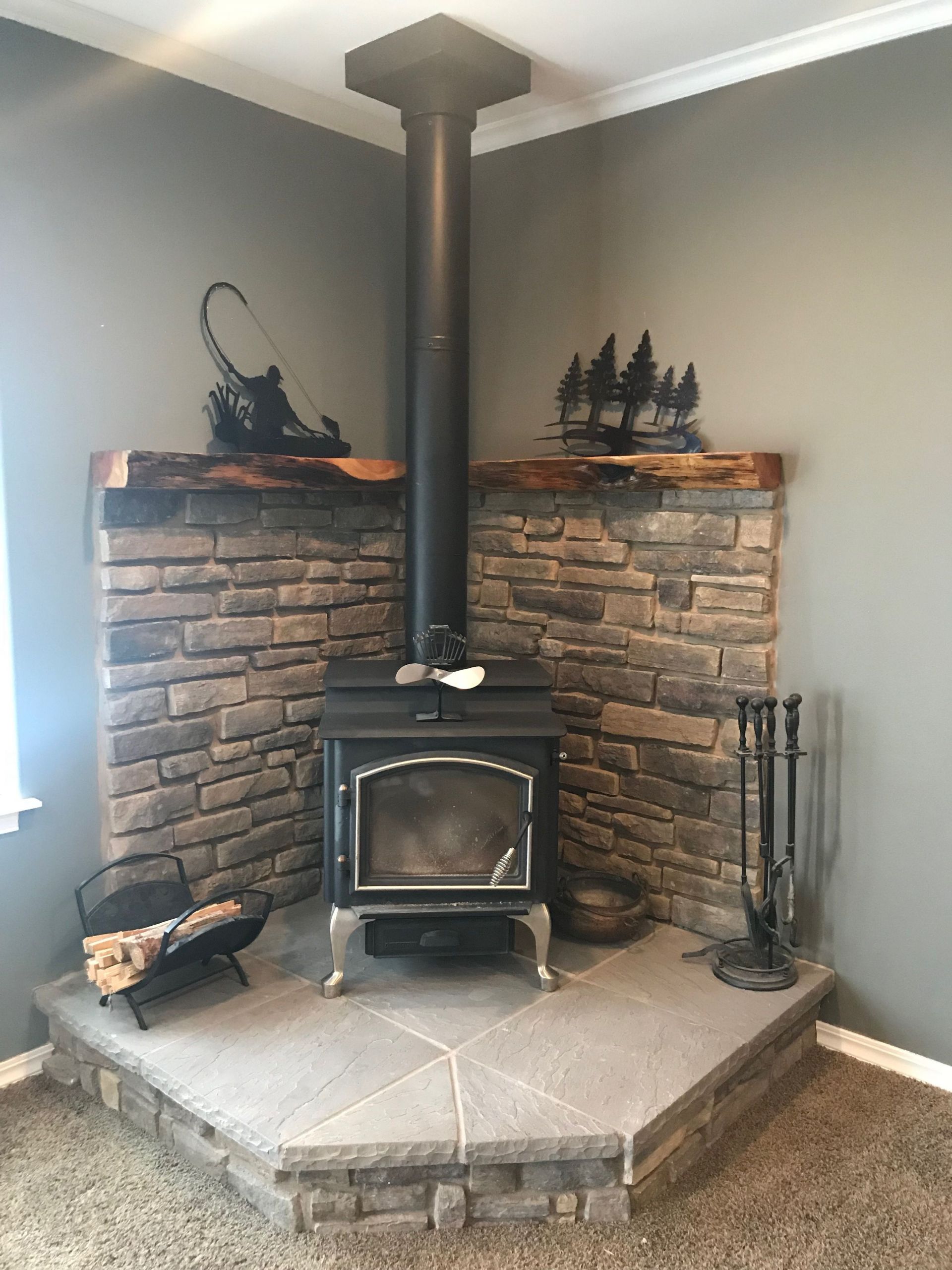 DIY Wood Stove Hearth
 Corner wood stove fireplace with juniper mantel With
