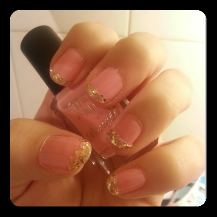 Light Pink Nails With Gold Glitter
 Light pink nails with gold glitter tips