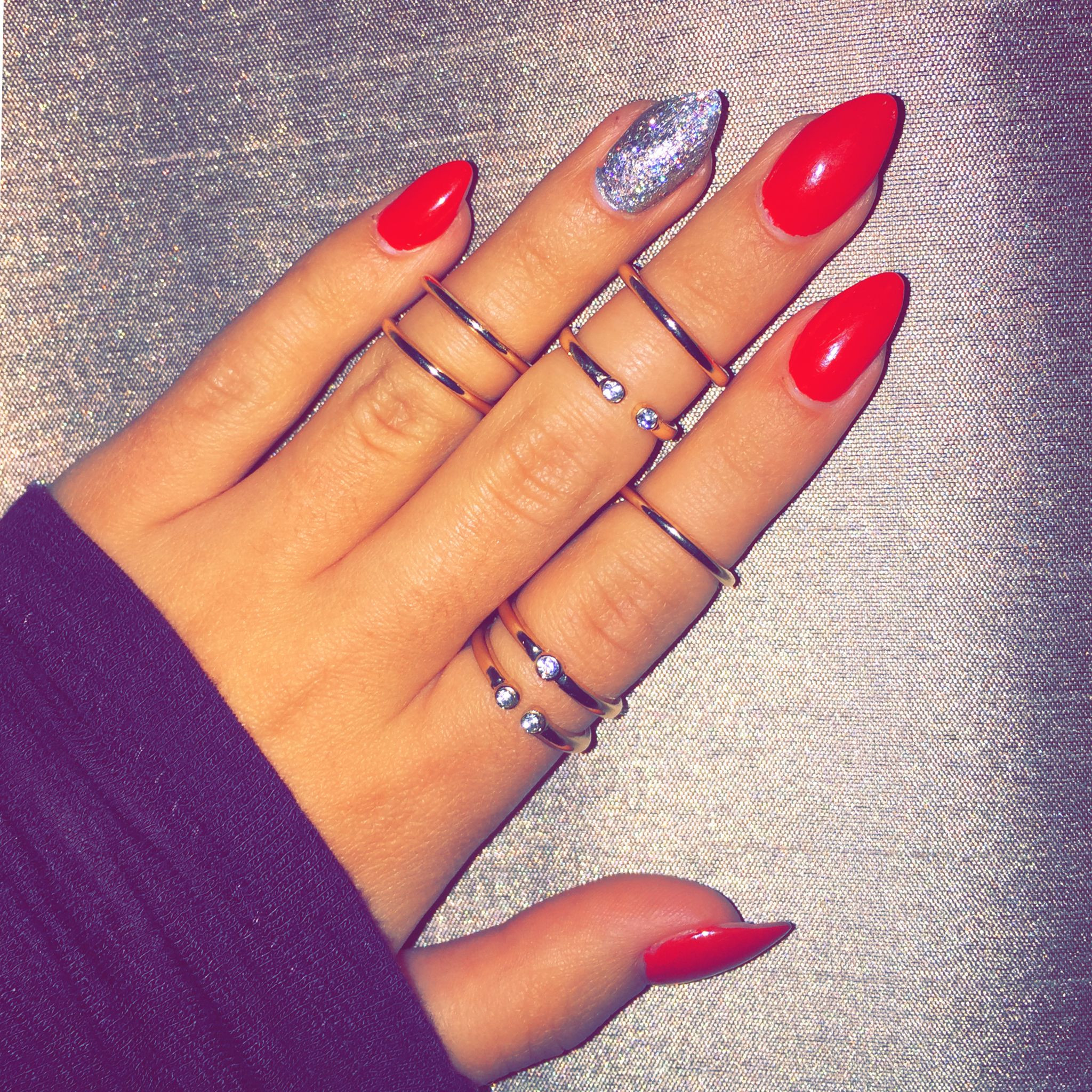 Red Nails With Silver Glitter
 Red stiletto nails with silver glitter accent paired with