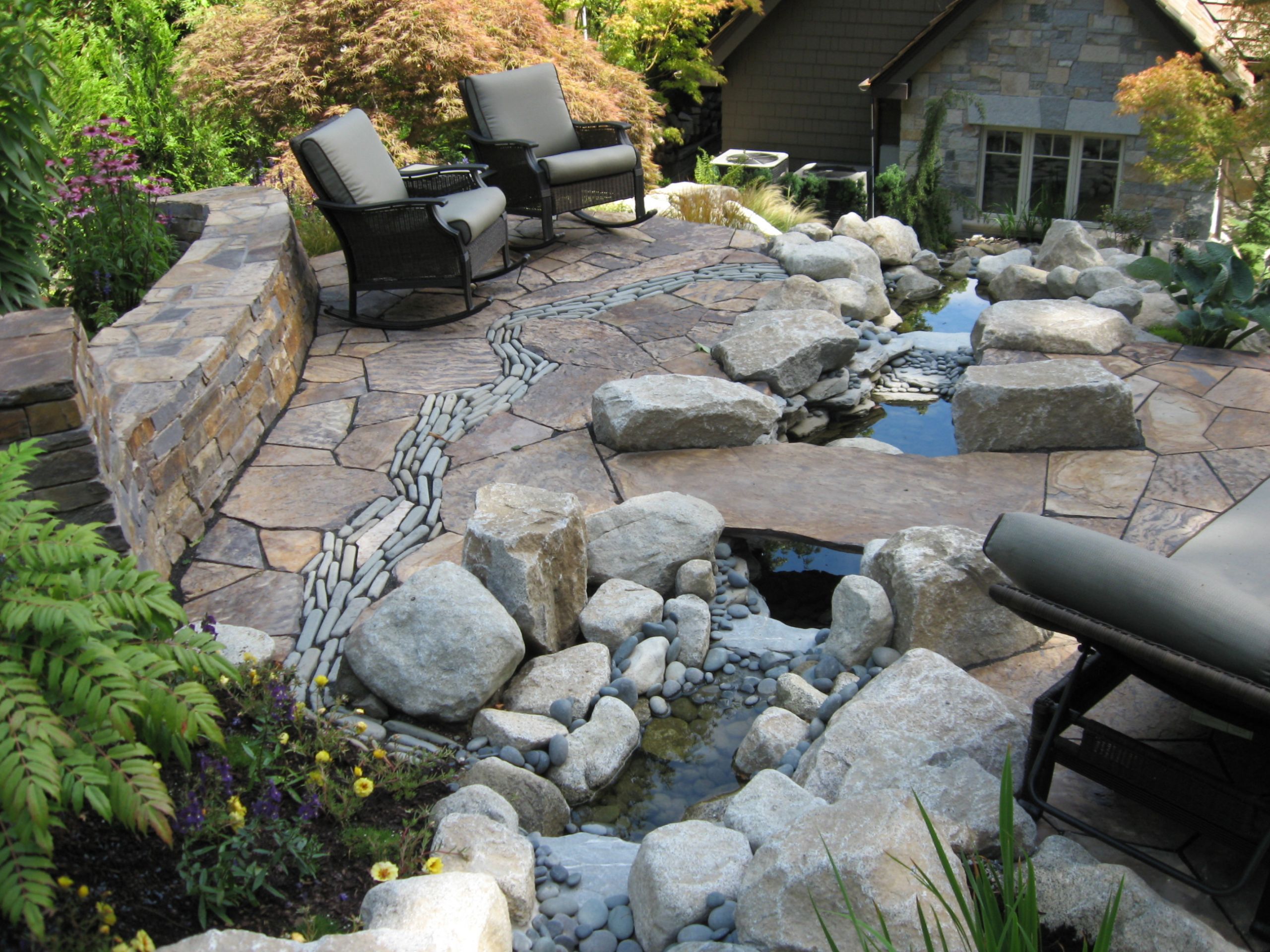 Stone Landscape Design
 Before and After – Patio with Stone River and Curved Stone